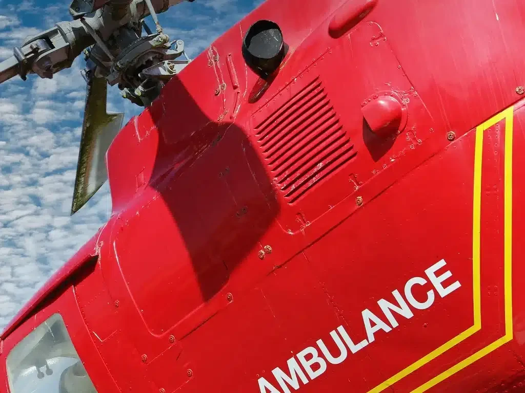 Close-up of a red air ambulance helicopter with its name on the side